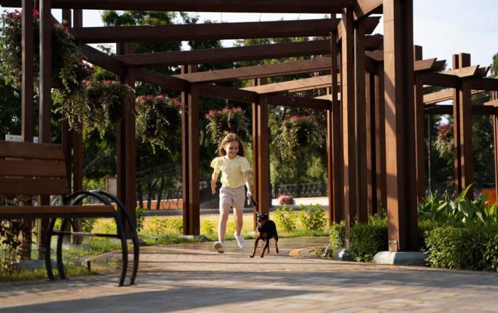 a kid and her dog running
